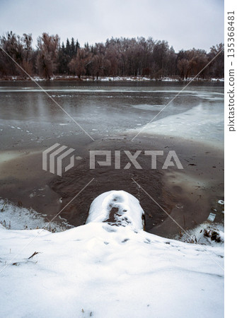 Wastewater flows from a pipe directly into the river 135368481