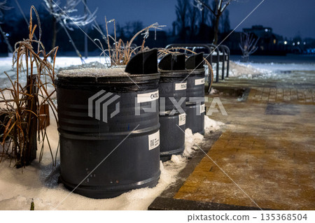 waste containers on a cold evening. Sustainable recycling in the city park. waste containers on a cold evening. Sustainable recycling in the city park. 135368504