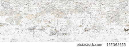 Old white painted wall showing peeling plaster texture 135368653
