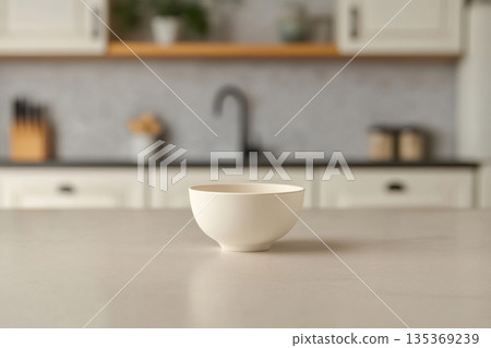 White ceramic bowl resting on a sleek countertop in a contemporary kitchen, poised for preparing a nutritious and delicious meal White ceramic bowl resting on a sleek countertop in a contemporary kitchen, poised for preparing a nutritious and delicious meal 135369239