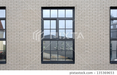 Brick wall reflecting industrial building in tallinn window Brick wall reflecting industrial building in tallinn window 135369653