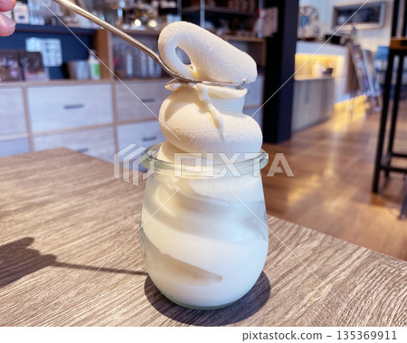 Milk soft serve ice cream: Rich milk ice cream served in a glass. 135369911