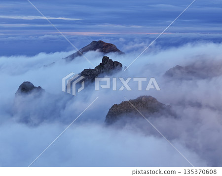 Misty mountain ridge at twilight, guides scouting view Misty mountain ridge at twilight, guides scouting view 135370608