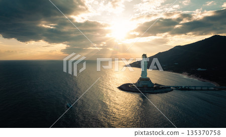 Guanyin statue at seaside in nanshan temple, hainan island , China. Words mean mercy and blessing. 135370758