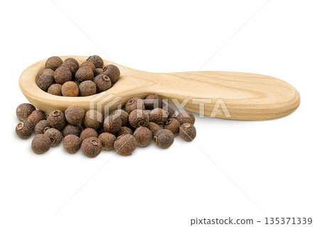 Allspice pepper in wooden spoon isolated on white background. Jamaica pepper, Pimenta dioica or myrtle pepper. 135371339