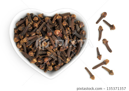 dry spice cloves in ceramic bowl isolated on white background. Top view. Flat lay 135371357