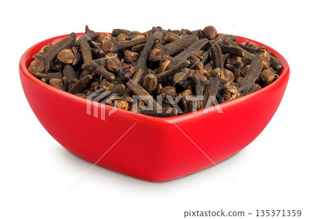 dry spice cloves in ceramic bowl isolated on white background. dry spice cloves in ceramic bowl isolated on white background. 135371359