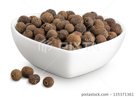 Allspice pepper in ceramic bowl isolated on white background. Jamaica pepper, Pimenta dioica or myrtle pepper. Allspice pepper in ceramic bowl isolated on white background. Jamaica pepper, Pimenta dioica or myrtle pepper. 135371361