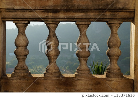 View from the balcony of the old temple onto the blooming garden.Architecture of the old temple. View from the balcony of the old temple onto the blooming garden.Architecture of the old temple. 135371636