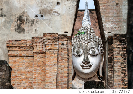 Big Buddha statue at Wat Si Chum temple in Sukhothai historical park Sukhothai, Thailand Big Buddha statue at Wat Si Chum temple in Sukhothai historical park Sukhothai, Thailand 135372157