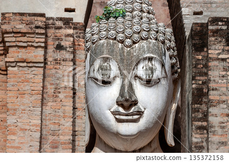 Big Buddha statue at Wat Si Chum temple in Sukhothai historical park Sukhothai, Thailand Big Buddha statue at Wat Si Chum temple in Sukhothai historical park Sukhothai, Thailand 135372158