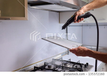 Utilizing Steam Cleaning Techniques on Kitchen Hood Filters for Effective Deep Cleaning Tasks 135372160