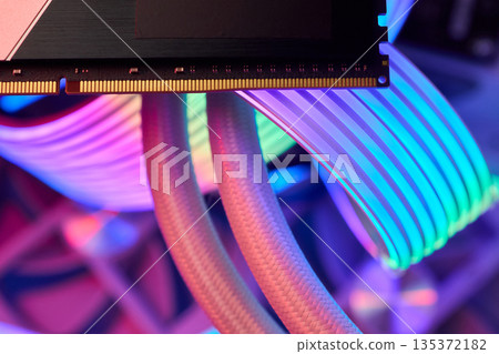 Elegant gaming hardware, High-performance RAM with cooling system, Premium illuminated memory module for gaming PCs, Sleek neon lit RAM with cooling and metallic heat sink design 135372182