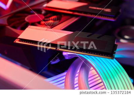 Elegant gaming hardware, High-performance RAM with cooling system, Premium illuminated memory module for gaming PCs, Sleek neon lit RAM with cooling and metallic heat sink design 135372184