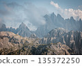 Dramatic alpine landscape of the Dolomites near Tre Cime di Lavaredo with jagged limestone peaks emerging through soft clouds in a serene high altitude mountain wilderness 135372250