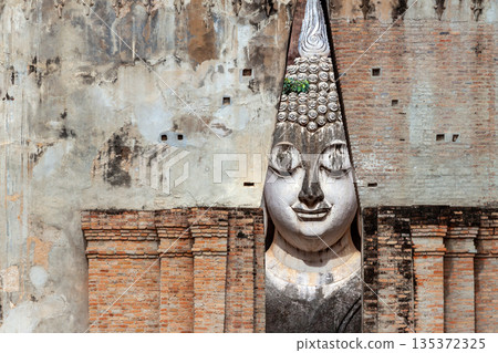 Big Buddha statue at Wat Si Chum temple in Sukhothai historical park Sukhothai, Thailand Big Buddha statue at Wat Si Chum temple in Sukhothai historical park Sukhothai, Thailand 135372325