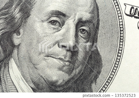 Close-up view of Benjamin Franklin on hundred dollar bill currency in clear focus 135372523