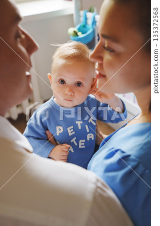 Family moment with baby in cozy indoor setting Family moment with baby in cozy indoor setting 135372568