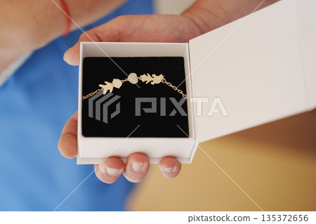 Beautiful bracelet held in a gift box during an event 135372656