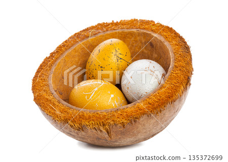 Colorful eggs placed in a coconut bowl for decoration at spring celebration event 135372699