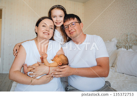 Family spends time together at home with newborn baby Family spends time together at home with newborn baby 135372753