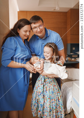 Family celebrates new baby in hospital room Family celebrates new baby in hospital room 135372774