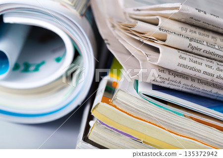 Piles of magazines and newspapers stacked for organization and storage in a home or office Piles of magazines and newspapers stacked for organization and storage in a home or office 135372942