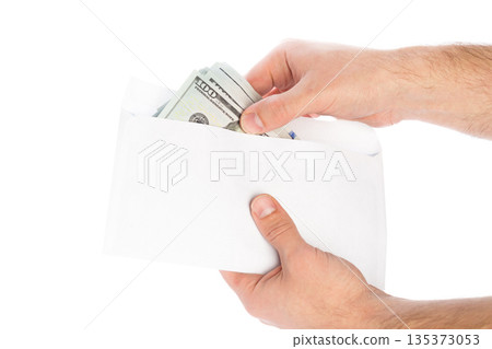 Person holds an envelope containing cash in hands ready to give money Person holds an envelope containing cash in hands ready to give money 135373053
