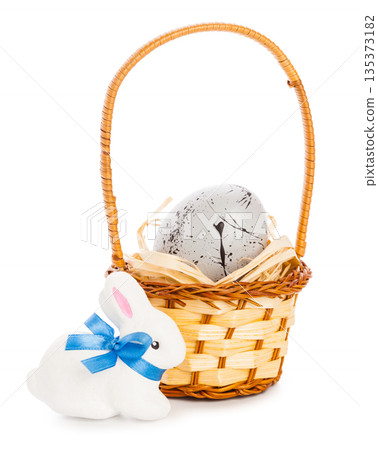 Bunny and basket with egg during spring holiday celebration Bunny and basket with egg during spring holiday celebration 135373182