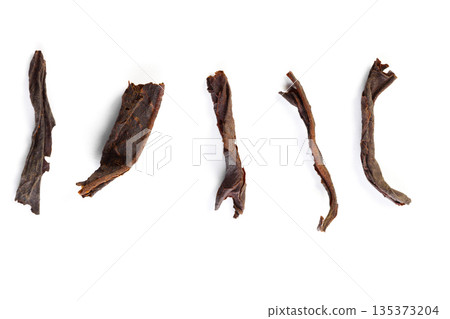Dried herbal material arranged on a white background showing different shapes and sizes 135373204