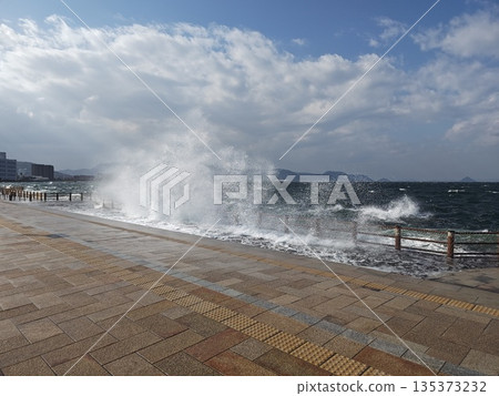 Waves hitting the breakwater Waves hitting the breakwater 135373232