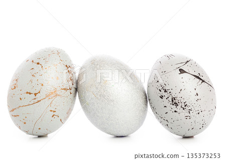 Decorative eggs arranged in a row on a white background during the spring season Decorative eggs arranged in a row on a white background during the spring season 135373253
