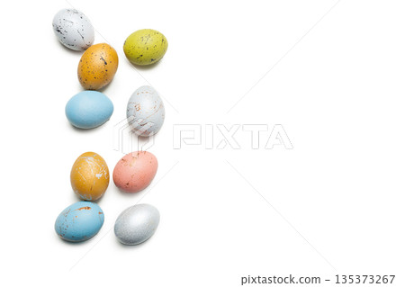 Colorful eggs arranged in a playful design for a spring celebration or holiday event 135373267