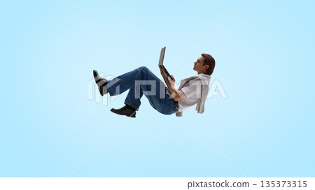 Casual man levitating with laptop in relaxed working posture. Casual man levitating with laptop in relaxed working posture. 135373315