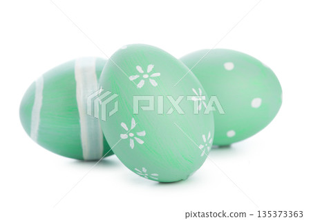 Decorative green eggs with white designs for spring celebration or holiday 135373363