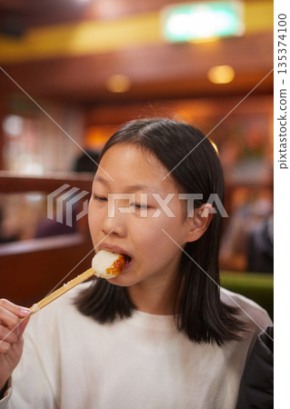 A cute junior high school girl eating mochi at a cafe in winter A cute junior high school girl eating mochi at a cafe in winter 135374100