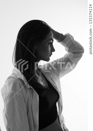A woman with black hair wakes up in the morning in a white blanket and catches the rays of the sun. The portrait is creative, with brown eyes. High quality photo A woman with black hair wakes up in the morning in a white blanket and catches the rays of the sun. The portrait is creative, with brown eyes. High quality photo 135374114
