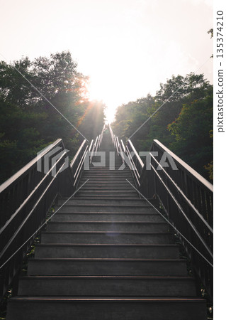Stairs lit by the setting sun Stairs lit by the setting sun 135374210