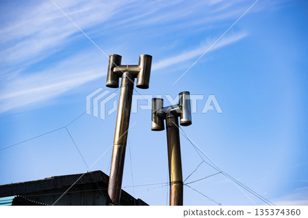 Stainless steel chimney on the roof Stainless steel chimney on the roof 135374360