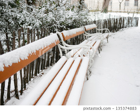 Snow-Covered Benches in Quiet Urban Park Snow-Covered Benches in Quiet Urban Park 135374883