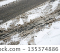 Dirty Snow and Tire Tracks on Winter Road, Slush Background 135374886