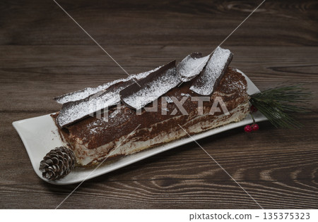 Tiramisu Tronchetto Dessert, Italian Yule Log Christmas dessert with chocolate bark 135375323