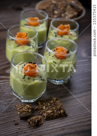 Smoked salmon shot glasses guacamole served with homemade crackers Smoked salmon shot glasses guacamole served with homemade crackers 135375415