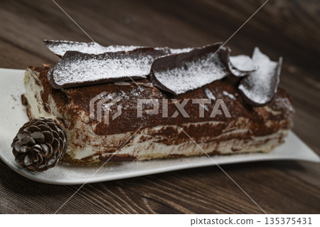 Tiramisu Tronchetto Dessert, Italian Yule Log Christmas dessert with chocolate bark 135375431