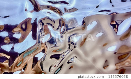 shimmering liquid metal waves rippling in ethereal blue gold tones abstract fluid surface reflecting light for futuristic wallpaper background 135376058