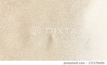 soft beige fabric texture closeup with subtle central dent and grainy weave evoking calm neutrality for wallpaper or banner background soft beige fabric texture closeup with subtle central dent and grainy weave evoking calm neutrality for wallpaper or banner background 135376080