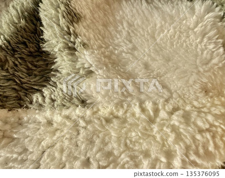 soft fluffy sheep wool closeup layered textures in earthy brown beige cream tones blending naturally for cozy wallpaper or textile banner 135376095