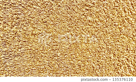 luxurious golden terry cloth texture macro shot with wavy fibrous loops evoking warmth for premium wallpaper or elegant design background luxurious golden terry cloth texture macro shot with wavy fibrous loops evoking warmth for premium wallpaper or elegant design background 135376110