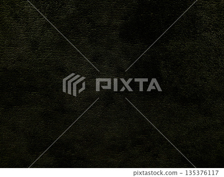 dark textured black fabric closeup with subtle green hues evoking mysterious eerie mood ideal for horror wallpaper or spooky banner background 135376117