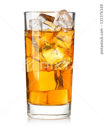 Iced tea glass containing refreshing cold amber liquid 135376189